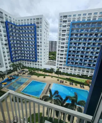 a view from a balcony of two large buildings at MNM Place - Sea Residence 0A in Manila