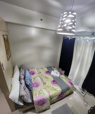 a small bedroom with a bed in a room at MNM Place - Sea Residence 0A in Manila