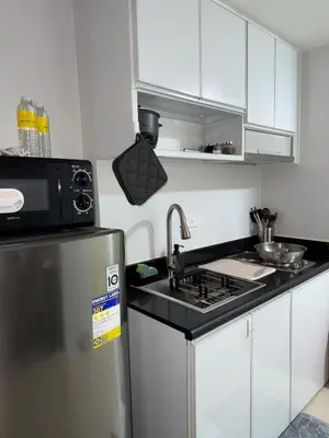 a kitchen with a sink and a refrigerator at Jazz mall Tower 4 Rm 323 Spacious 1 bedroom with Balcony netflix 100mbps in Manila