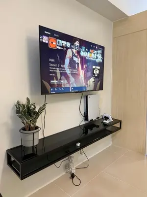 a flat screen tv hanging on a wall at Jazz mall Tower 4 Rm 323 Spacious 1 bedroom with Balcony netflix 100mbps in Manila