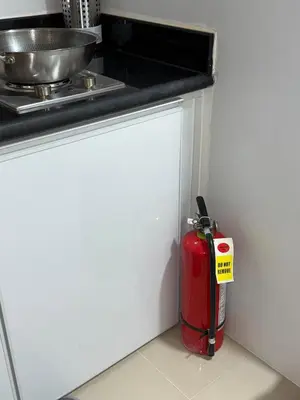 a red fire hydrant sitting in the corner of a kitchen at Jazz mall Tower 4 Rm 323 Spacious 1 bedroom with Balcony netflix 100mbps in Manila