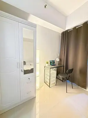 a white bedroom with a desk and a chair at Jazz mall Tower 4 Rm 323 Spacious 1 bedroom with Balcony netflix 100mbps in Manila