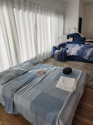 a bedroom with a bed with a towel on it at Family room with private pool in Manila