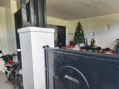 a christmas tree in a living room with a fireplace at Family room with private pool in Manila
