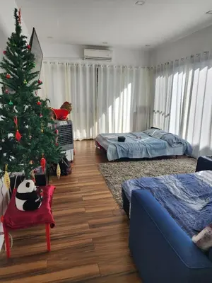 a living room with a christmas tree and a bedroom at Family room with private pool in Manila