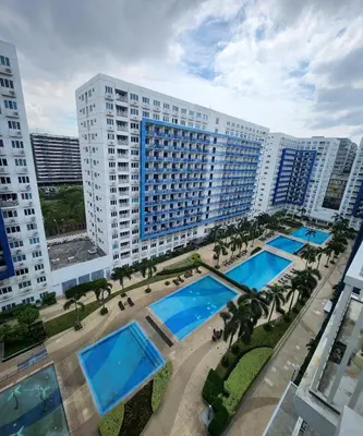 an aerial view of a large building with two pools at MNM Place - Sea Residence 0F in Manila