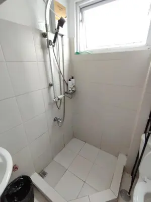 a bathroom with a shower and a sink at MNM Place - Sea Residence 0F in Manila