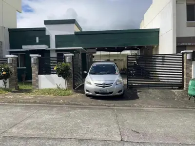 a silver car parked in front of a building at NRD Staycation Transient House in Dasmariñas