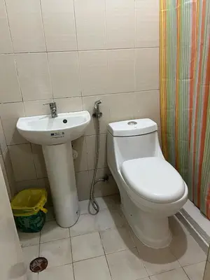a bathroom with a toilet and a sink at NRD Staycation Transient House in Dasmariñas