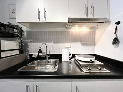 a kitchen with a sink and a counter top at Jazz Residence T2 Rm 405 Homey Muji Inspired Staycation Big Screen Cinema in Manila