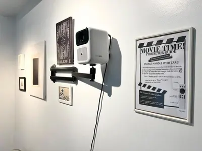 a room with a tv on a wall with pictures at Jazz Residence T2 Rm 405 Homey Muji Inspired Staycation Big Screen Cinema in Manila