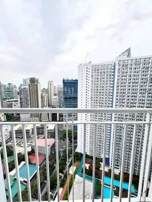 a view of the city from the balcony of a building at Jazz Residence T2 Rm 405 Homey Muji Inspired Staycation Big Screen Cinema in Manila