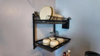 a shelf with candles and a mirror on a wall at Studio near SM Megamall 400MBPS Netflix Disney HBO in Manila