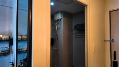 a room with a closet with a shower in it at Studio near SM Megamall 400MBPS Netflix Disney HBO in Manila