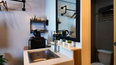 a bathroom with a sink and a mirror at Studio near SM Megamall 400MBPS Netflix Disney HBO in Manila