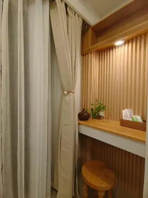 a curtain in a room with a table and a stool at Cozy Simple Room by Metro Staycation in Manila