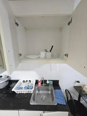 a kitchen with a sink and a counter top at MNM Place - Sea Residence 8D in Manila