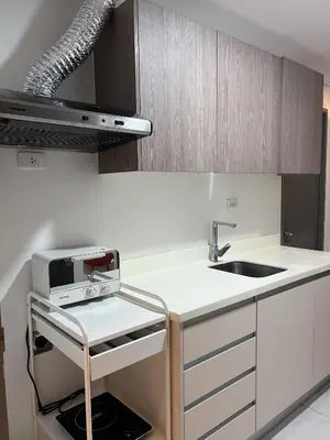 a kitchen with a sink and a microwave at The Bauhaus near Eastwood in Manila