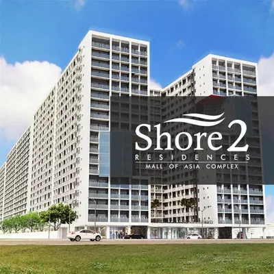 a large white building with a sign on it at The Grand Staycation at MOA - Unit 7102 Hotel-like in Manila