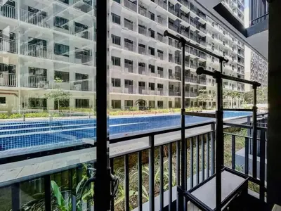 a view of a swimming pool from a balcony of a building at Cozy Haven 2 in Manila