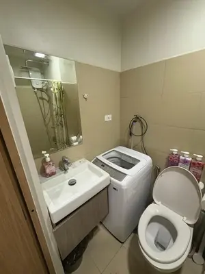 a small bathroom with a toilet and a sink at Cozy Haven 2 in Manila