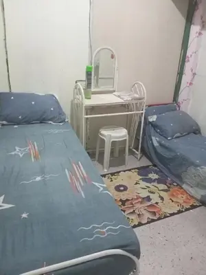 a room with a bed and a desk and a mirror at Springbreak Residence in Manila