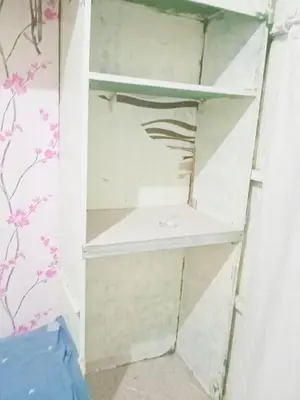 a shelf in a room with a wall at Springbreak Residence in Manila