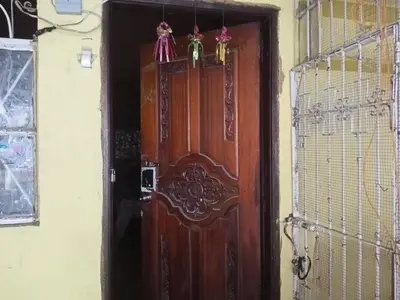 a wooden door in a room with a fence at Springbreak Residence in Manila