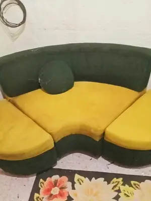 a yellow and black couch sitting in a room at Springbreak Residence in Manila