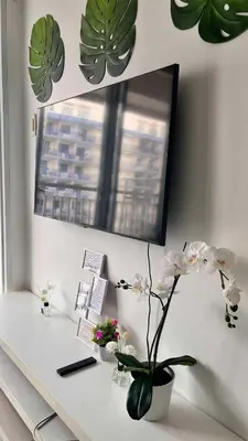 a white desk with a mirror and some plants at MNM Place - Sea Residence 1B in Manila