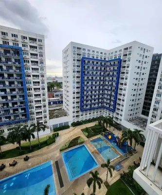 an aerial view of apartment buildings and a pool at MNM Place - Sea Residence 1B in Manila