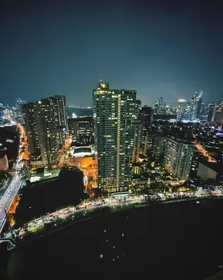 a view of a city at night with buildings at The Serene Escape Ph Rockwell Balcony View 1BR in Manila