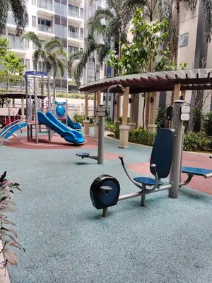 a playground with a slide and chairs in a park at Rqui Family Room Near Airport in Manila