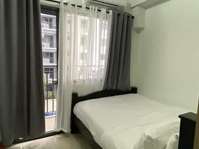 a bedroom with a bed and a window at Shore Residence a32 shortwalk Mall of Asia in Manila