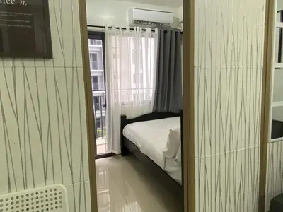 a small bedroom with a bed and a window at Shore Residence a32 shortwalk Mall of Asia in Manila