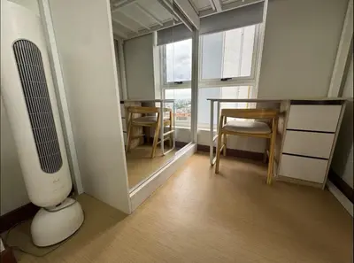 a room with a heater and a table and chairs at 2BR Resort Type condo w city view Sheridan in Manila