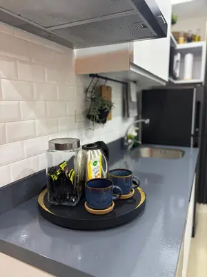 a kitchen counter with cups and a tray on it at The Villa at Azure South - Bahamas in Manila