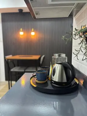 a tea kettle and two cups on a counter at The Villa at Azure South - Bahamas in Manila