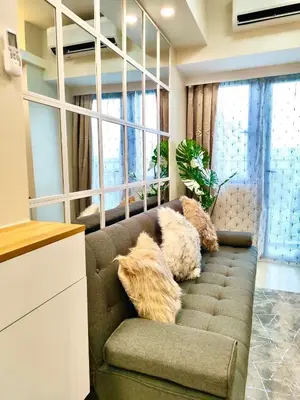 a living room with a couch with pillows on it at Scandi-Style & Organic condo Shore 3 MOA in Manila