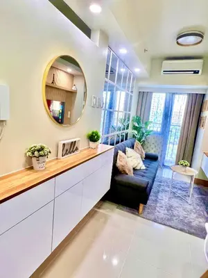a living room with a couch and a mirror at Scandi-Style & Organic condo Shore 3 MOA in Manila