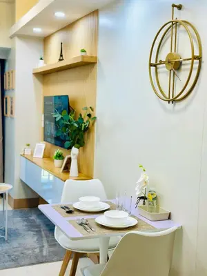 a dining room with a table and chairs at Scandi-Style & Organic condo Shore 3 MOA in Manila