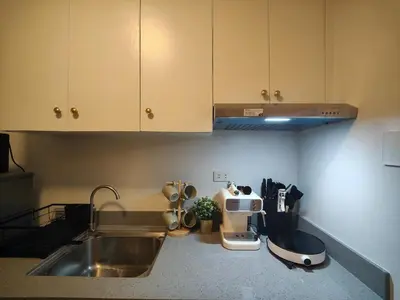 a kitchen with a sink and a counter top at The Hmlet Manila, Near Poblacion Makati Nightlife in Manila
