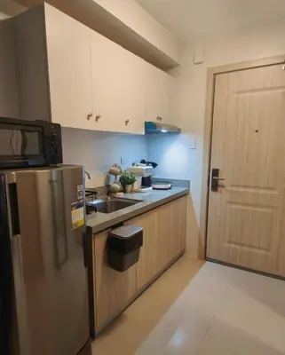 a small kitchen with a sink and a refrigerator at The Hmlet Manila, Near Poblacion Makati Nightlife in Manila