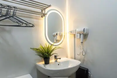 a bathroom with a sink and a mirror at The Hmlet Manila, Near Poblacion Makati Nightlife in Manila