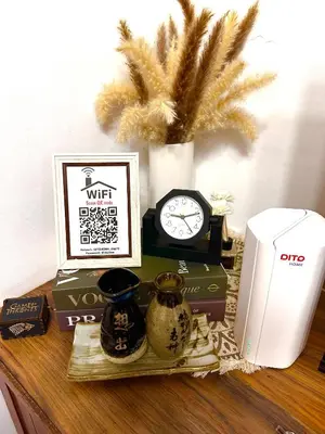 a table with a clock and other items on it at Isabelle Garden Villas Condominium Paranaque City in Manila