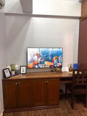 a flat screen tv sitting on top of a desk at Isabelle Garden Villas Condominium Paranaque City in Manila
