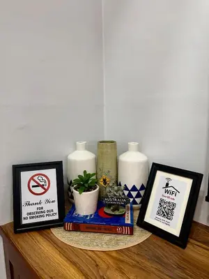 a shelf with three candles and pictures on it at Isabelle Garden Villas Condominium Paranaque City in Manila