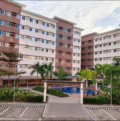 a large apartment building with a parking lot at Harmony Suite Hope Trece Cavite in Trece Martires
