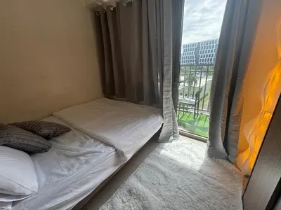 a small bedroom with a bed next to a window at Beach Haven Condo in MOAs Shore Resort near Okada City of Dreams Solaire in Manila
