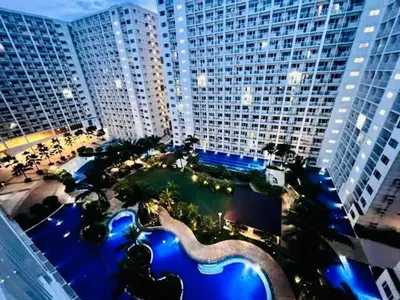 an aerial view of a large building with a pool at Beach Haven Condo in MOAs Shore Resort near Okada City of Dreams Solaire in Manila